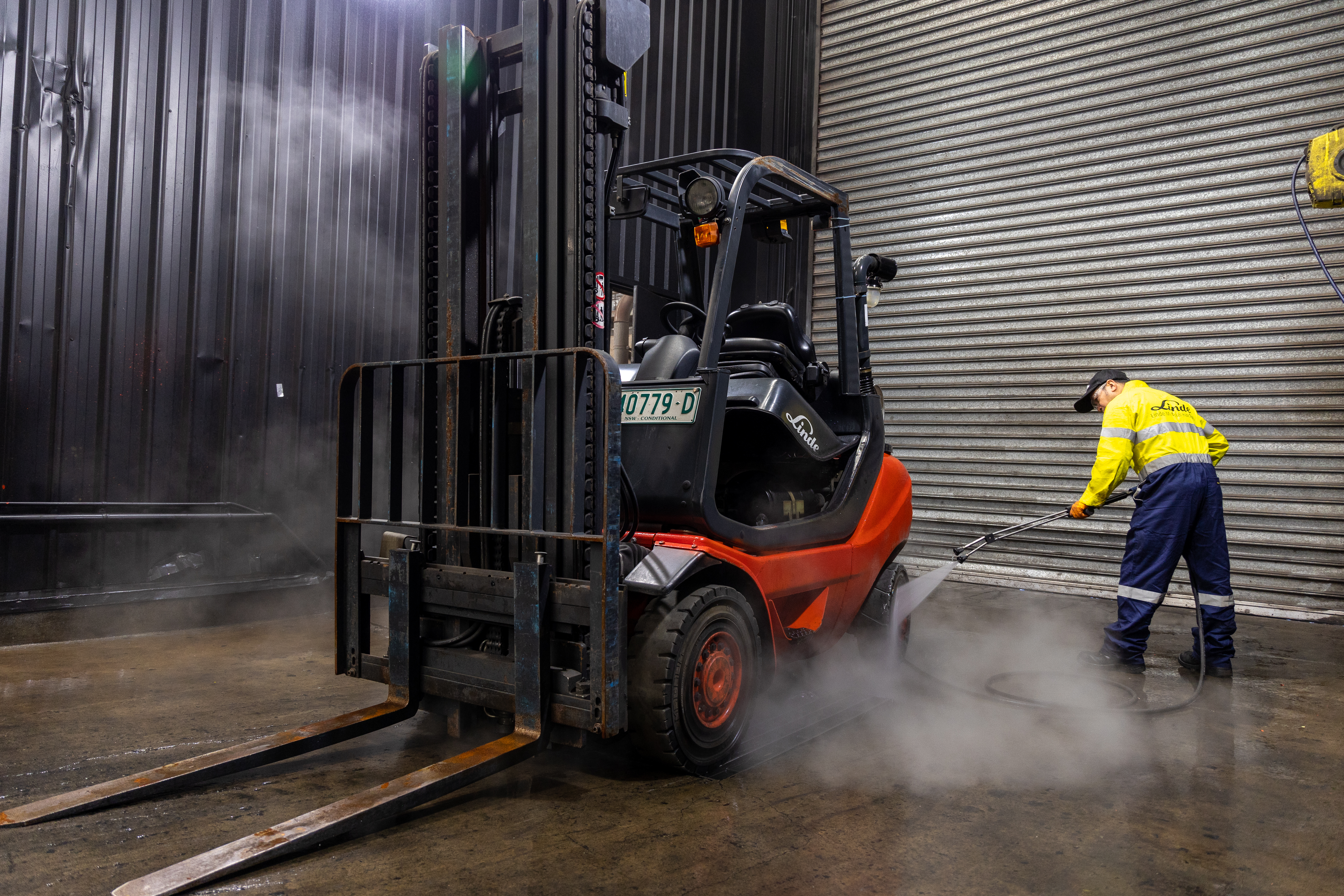 Linde Service Technician Cleaning Forklift