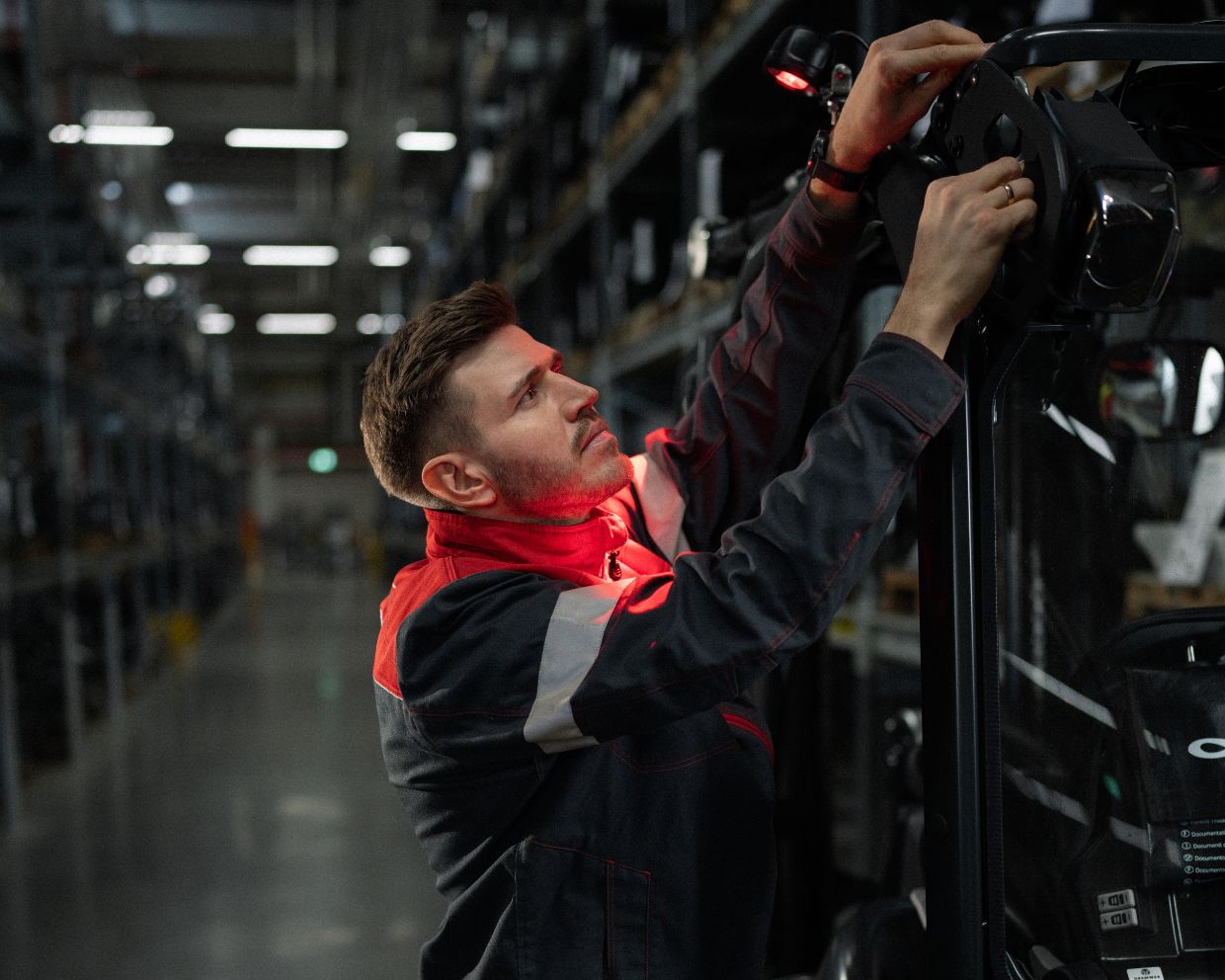 Linde service technician servicing a Linde forklift