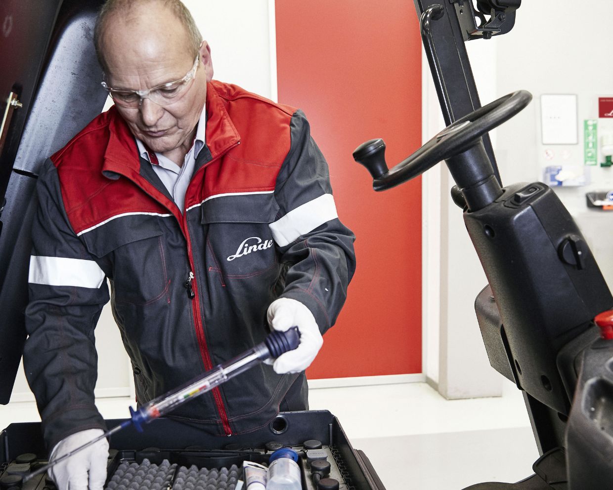 Man fixing forklift