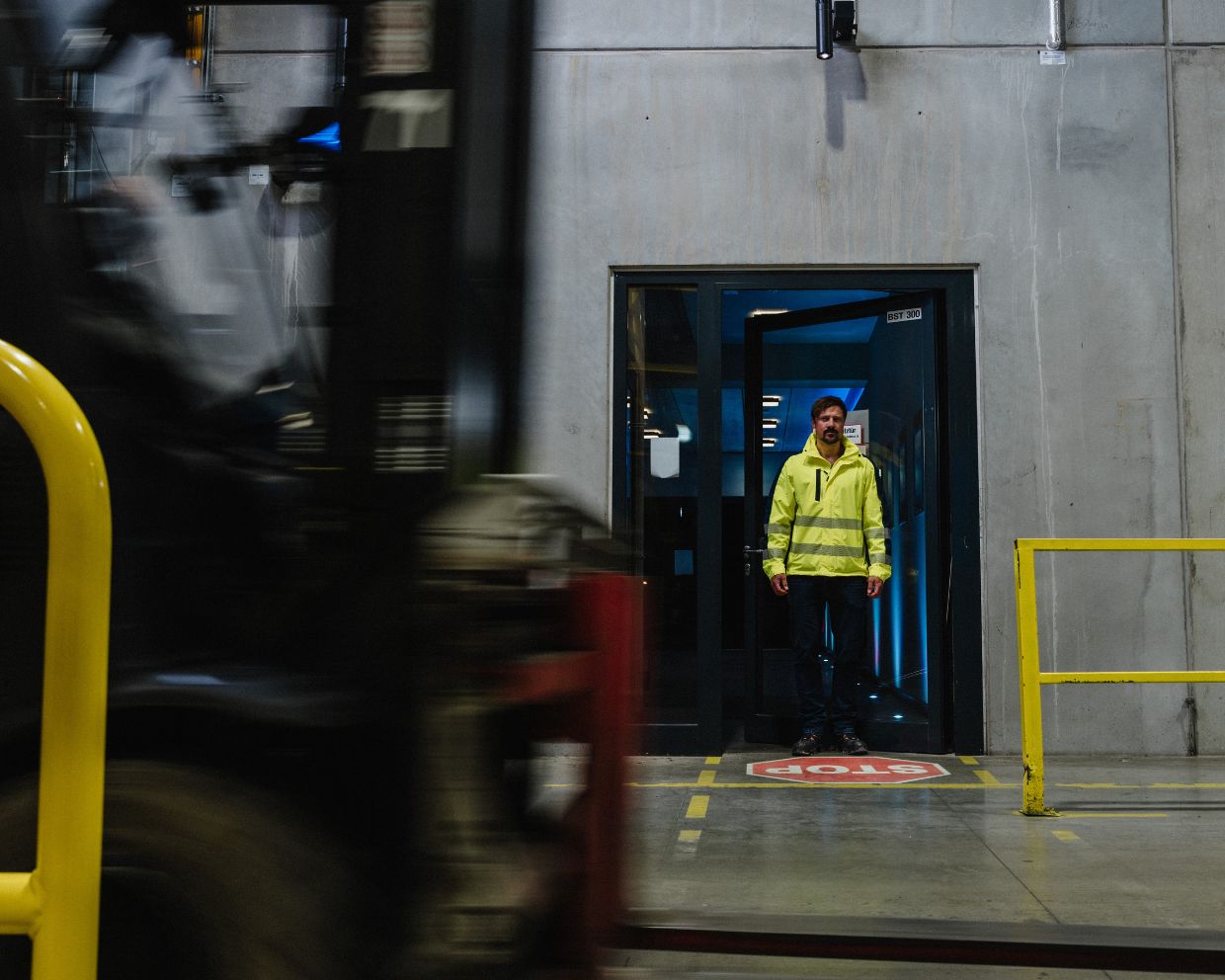 Worker observing forklift truck safety