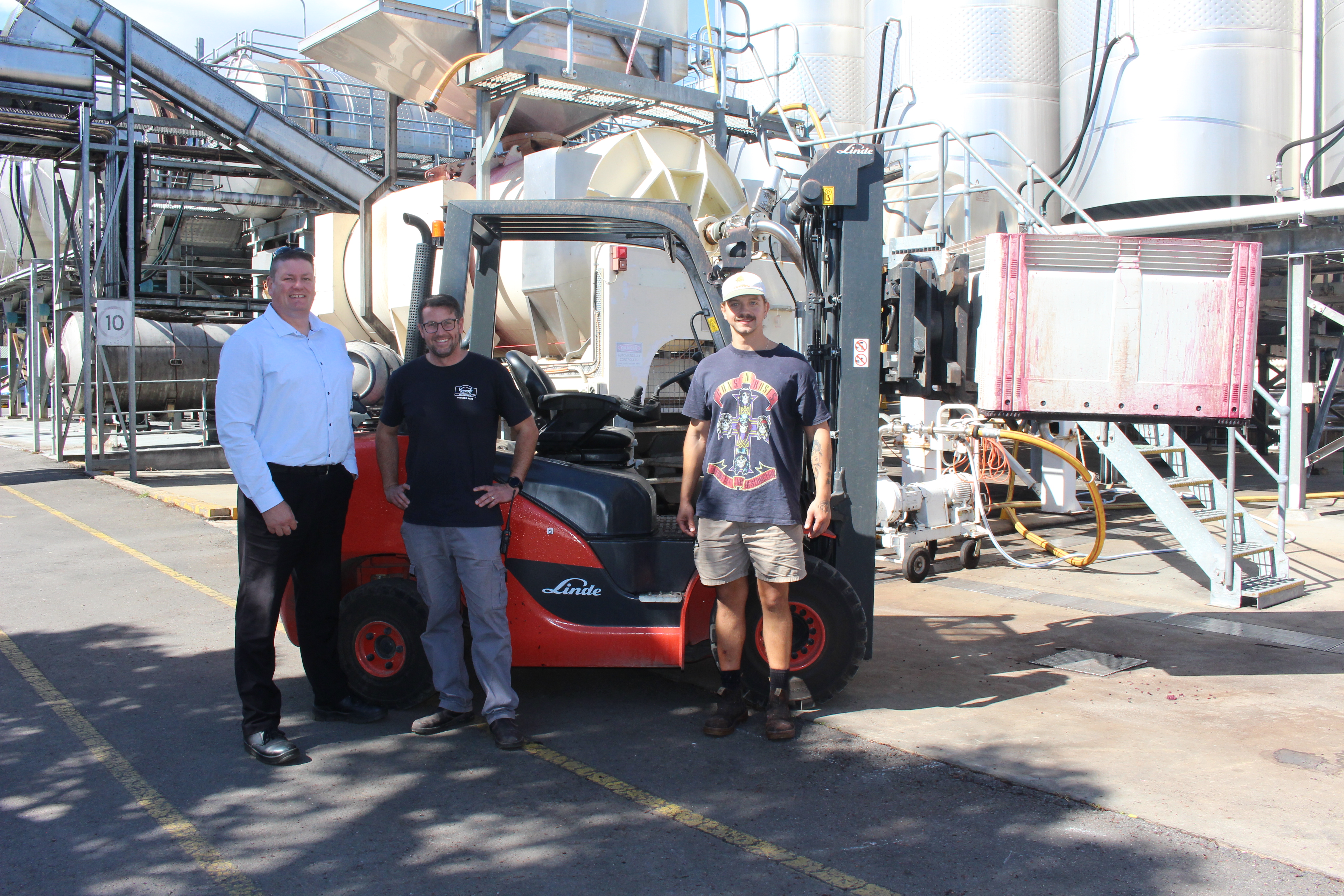 Linde Wine Industry Specialist with Ryecroft Manager and forklift operator in front of red Linde forklift on winery